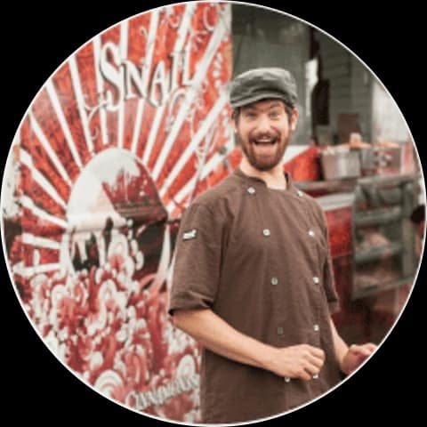 Chef Adam Sobel in front of the Cinnamon Snail food truck
